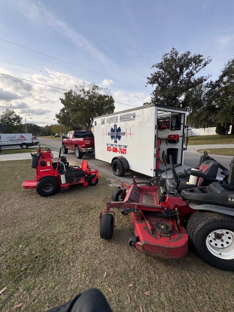 The Mower Medics mobile repair trailer and zero-turn mowers being serviced on site